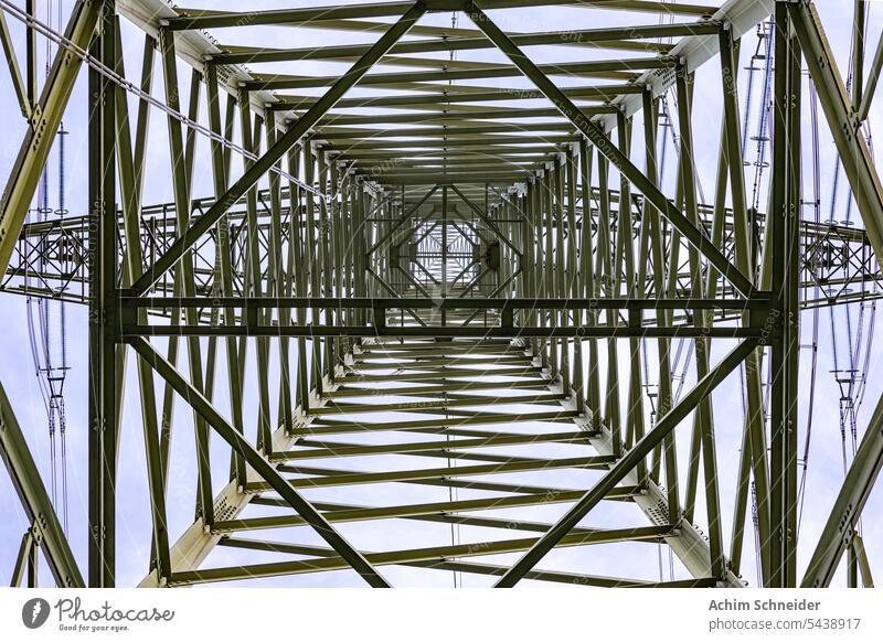 Symmetrical bottom-up view from a high voltage pylon with lines of steel girders Electricity pylon Worm's-eye view wires Pylon Steel construction Power grid