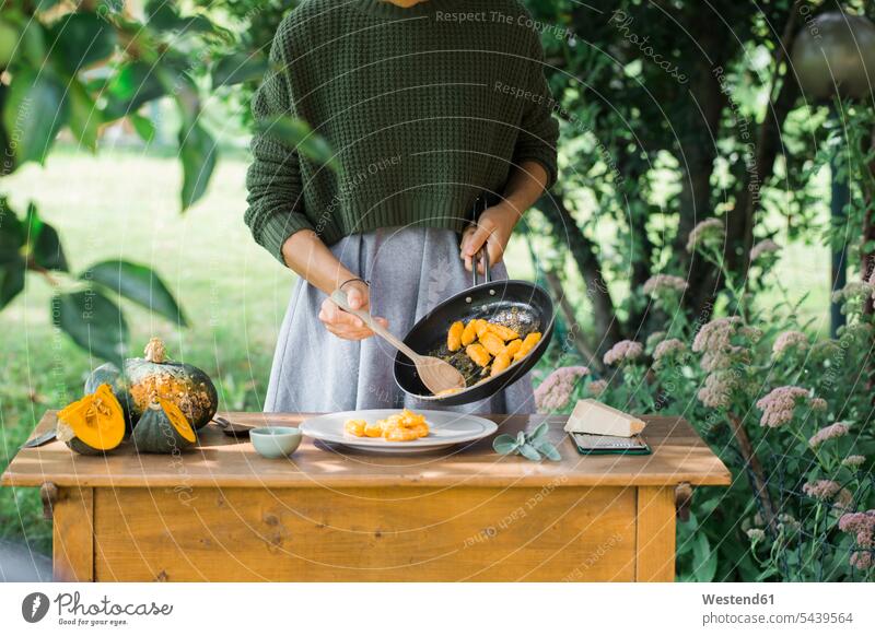 Young woman with homemade pumpkin gnocchi, partial view Pumpkin Pumpkins Squash females women Vegetable Vegetables Food foods food and drink Nutrition