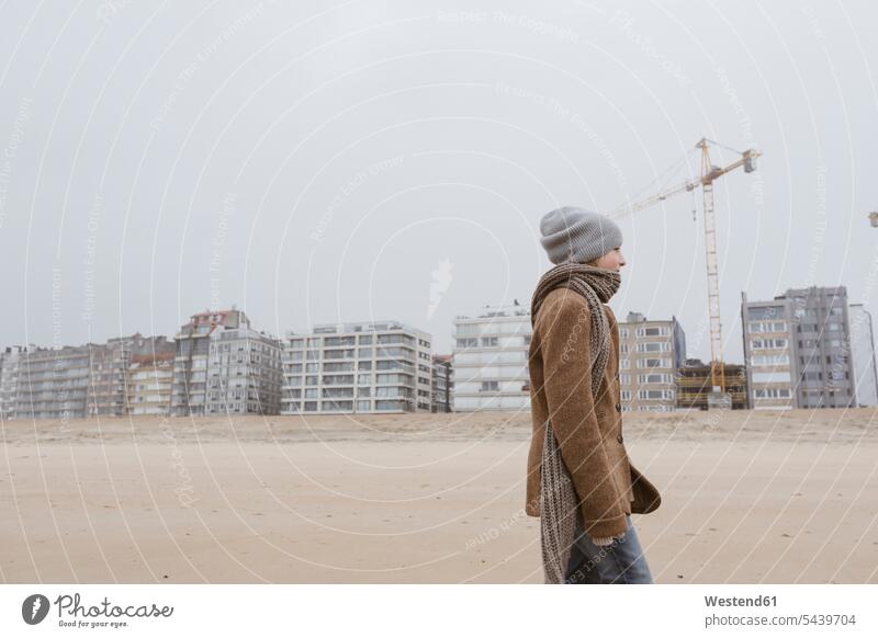 Germany, North Sea Coast, boy strolling on the beach in winter hibernal beach stroll walking along the beach walk along the beach beaches going boys males coast