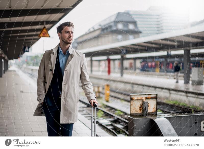 Businessman waiting at the platform Railroad Platform Business man Businessmen Business men train station transportation business people businesspeople