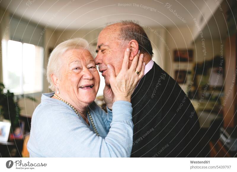 Affectionate senior couple at home caucasian caucasian ethnicity caucasian appearance european happiness happy enjoying indulgence enjoyment savoring indulging