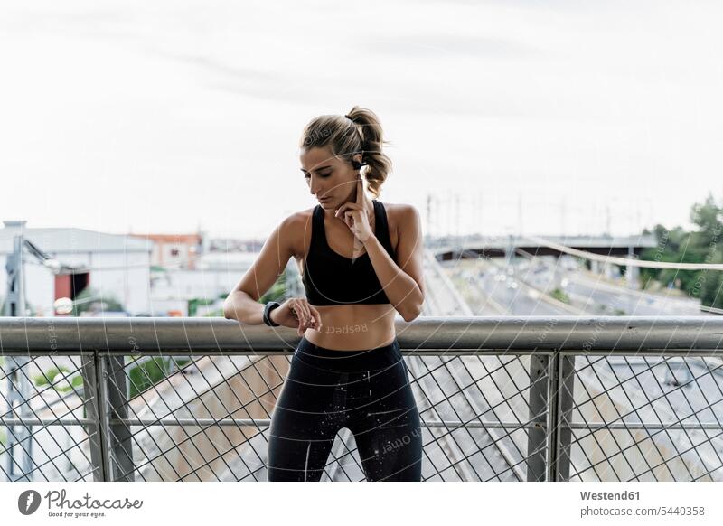 Sporty woman checking her heart rate human human being human beings humans person persons caucasian appearance caucasian ethnicity european adult grown-up