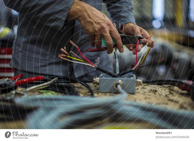 Close-up of mechanics hands in workshop cable power cord cables worker blue collar worker workers blue-collar worker pliers grippers man men males working