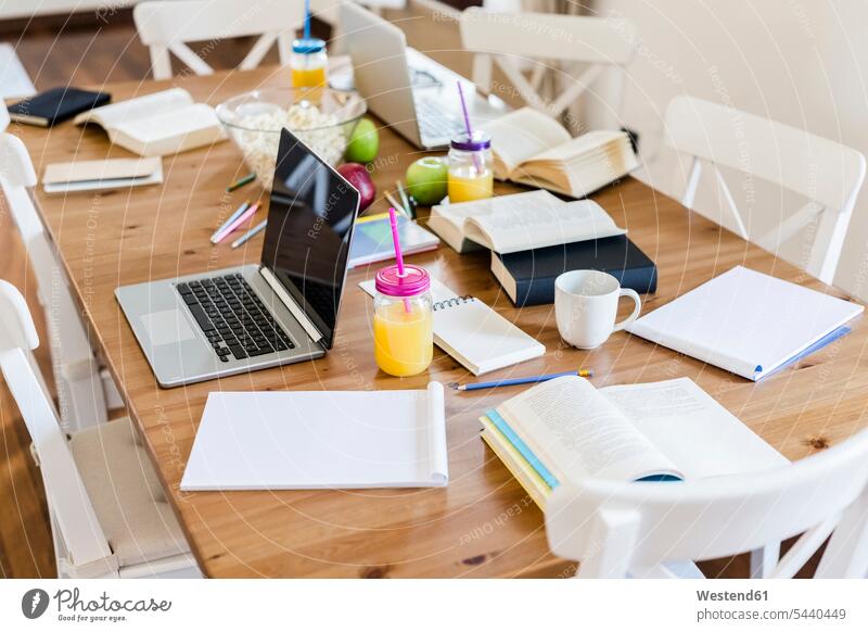 Laptop, books and notepads on a wooden table at home laptop Laptop Computers laptops notebook Note Pad Note Pads Table Tables computer computers student