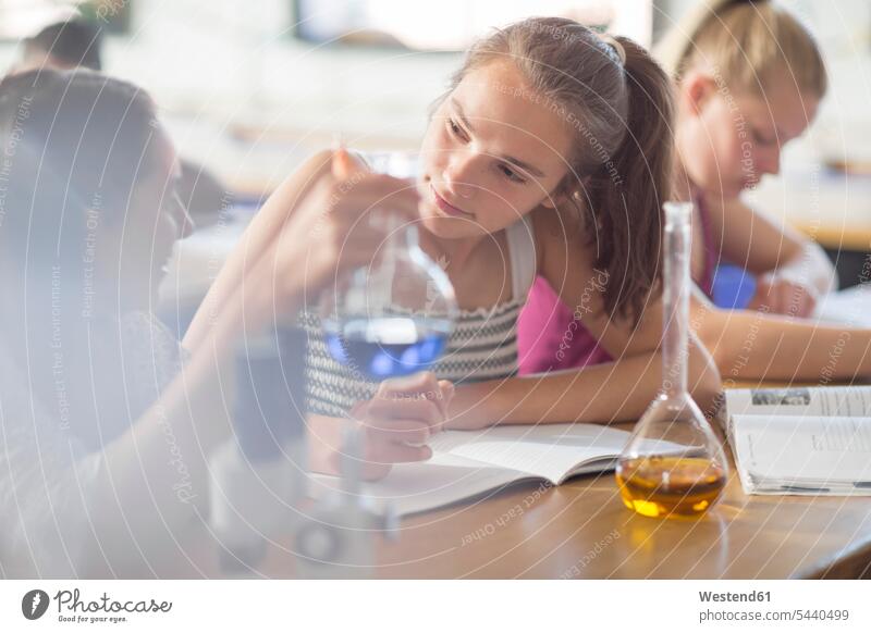 Teenage girls in high school chemistry class experimenting schoolgirl female pupils School Girl schoolgirls School Girls learning education effort attempt