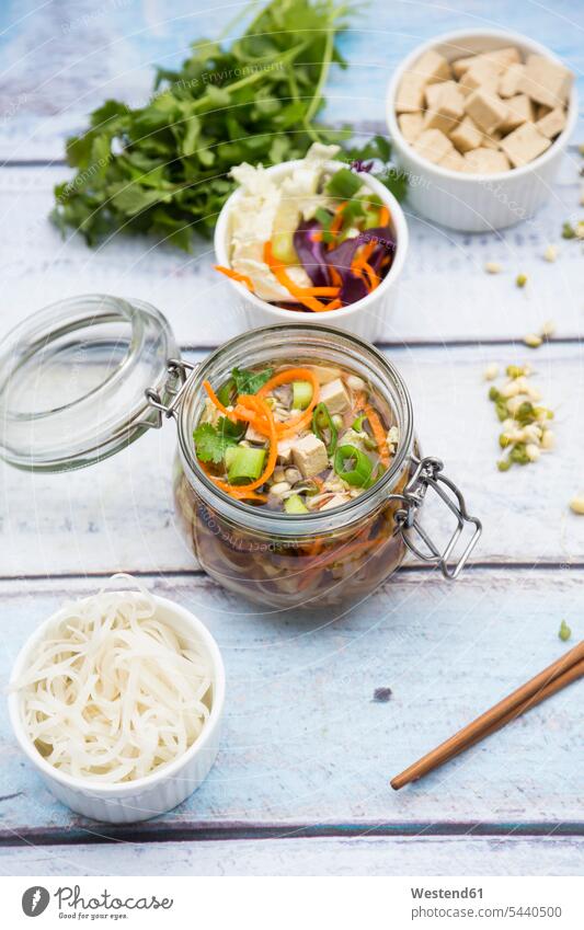 Asian rice noodle soup with vegetables and tofu in jar jars rice noodles garnished rich in vitamines coriander cilantro Coriandrum sativum ingredient