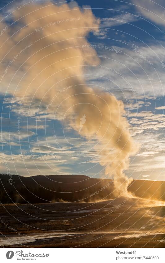 USA, Yellowstone Park, Wyoming, Old Faithful Geyser erupting geothermal evening mood Backlit back light backlight back lighting back lit sunset sunsets sundown