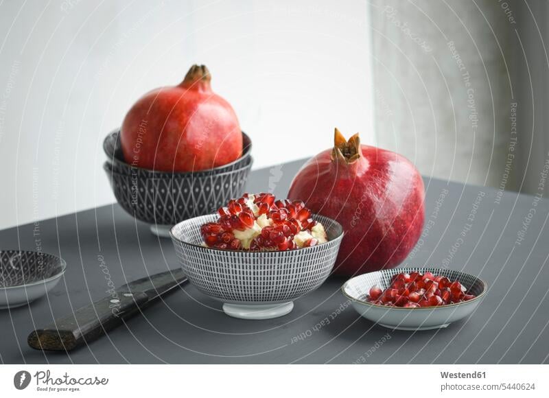 https://www.photocase.com/photos/5440624-pomegranate-and-pomegranate-seeds-in-bowl-knife-photocase-stock-photo-large.jpeg