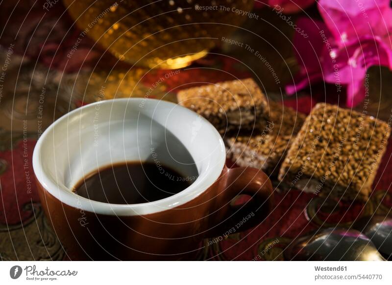 Cup of espresso and sesame almond brittle nobody spoon spoons sliced sesame brittle patterned sesame seeds Glass Bottle Glass Bottles Liqueur Liqueurs sweet