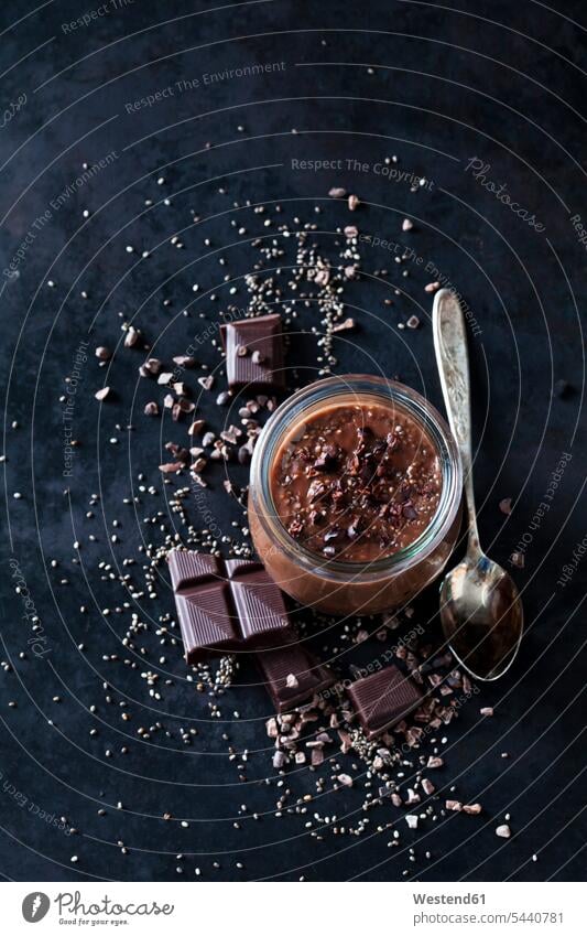 Dessert of chia seeds, chocolate and cacao nibs Glass Glasses Afters Desserts scattered dark background silver spoon Chia Seed trifle superfood