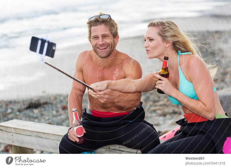 Couple having fun on the beach taking a selfie beaches laughing Laughter Selfie Selfies couple twosomes partnership couples mobile phone mobiles mobile phones