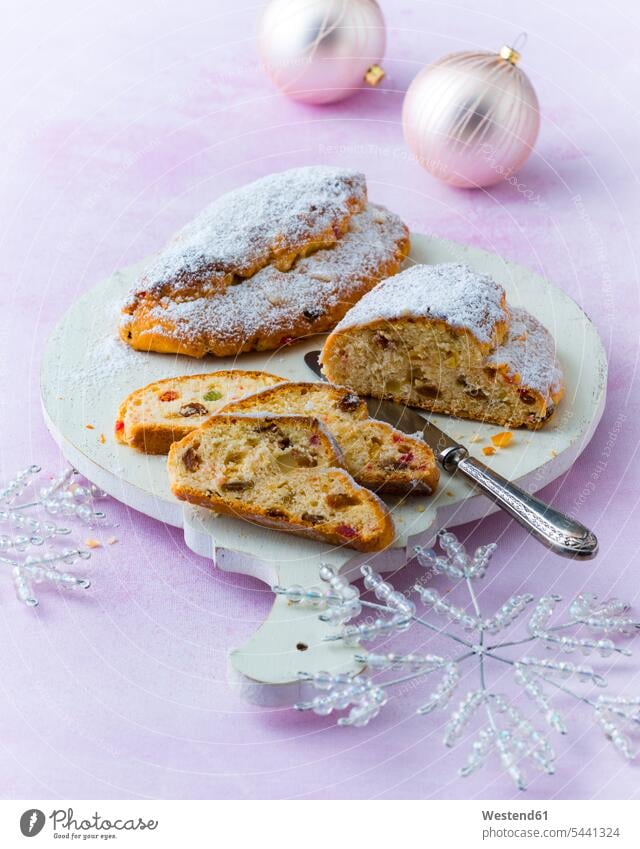 Stollen knife knives raisin raisins sliced wooden board wooden boards wooden panel wooden panels Christstollen yeast dough German Food German cuisine