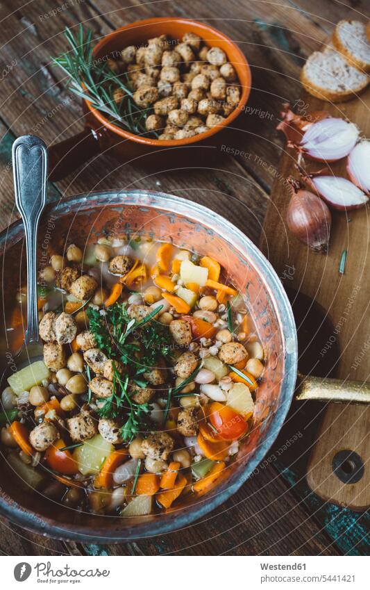 Mediterranean soup in copper pot, bowl of croutons and ingredients on wooden board dish dishes overhead view from above top view Overhead Overhead Shot