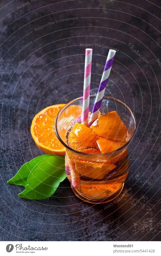 Fruit spritzer of tangerines in a glass with drinking straws overhead view from above top view Overhead Overhead Shot View From Above Refreshment refreshing