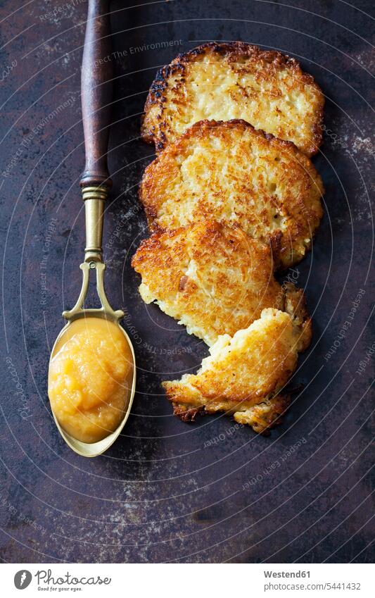 Potato fritters and spoon of apple sauce old prepared hearty savoury food lusty ready to eat ready-to-eat Potato Pancake Potato Pancakes potato pancakes rosti