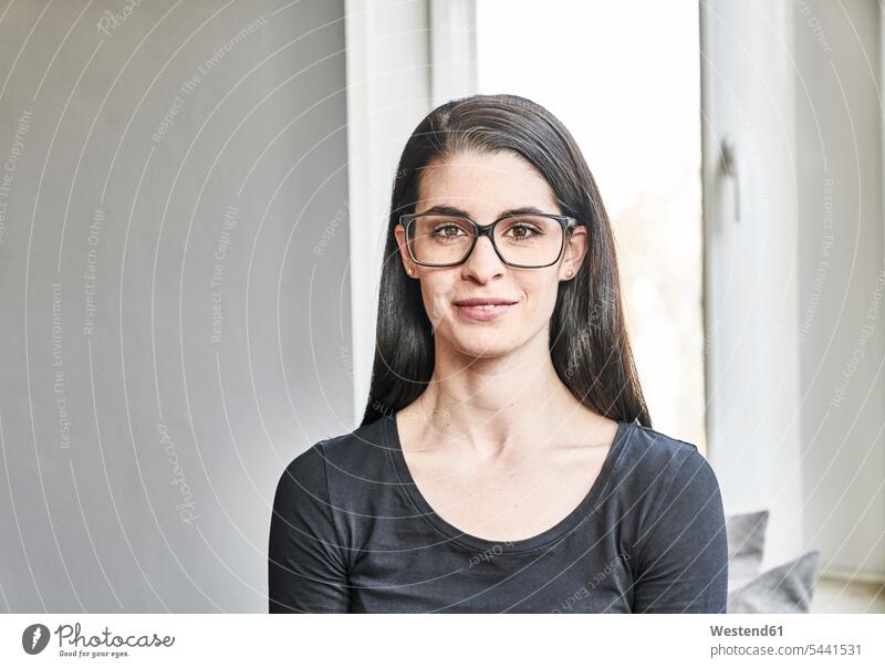 Portrait of smiling young woman with glasses smile females women portrait portraits Adults grown-ups grownups adult people persons human being humans