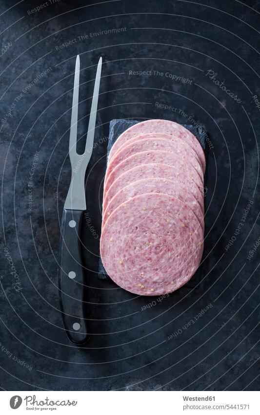 Sliced ham sausage with meat fork overhead view from above top view Overhead Overhead Shot View From Above sliced Chasseur Sausage Slices Sausages Fork Forks