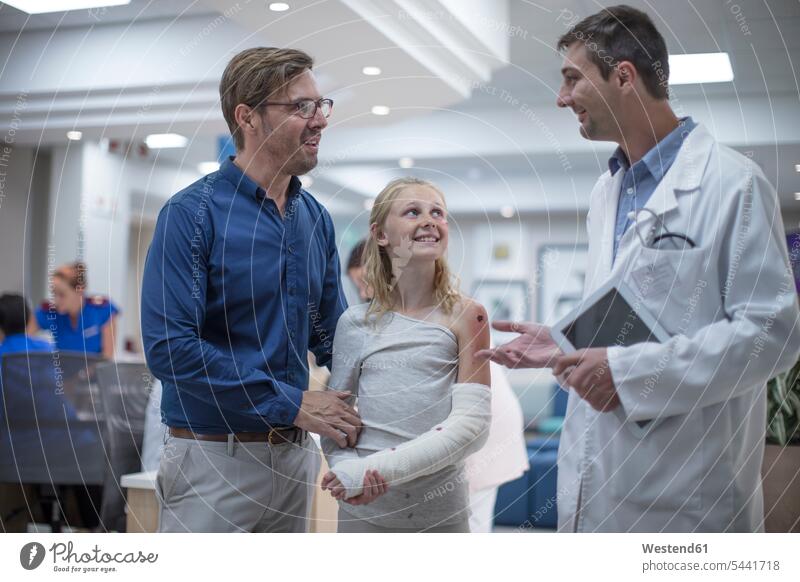 Sick girl greeting doctor at reception area in hospital father pa fathers daddy dads papa patient clinic hospitals daughter daughters Medical Clinic patients