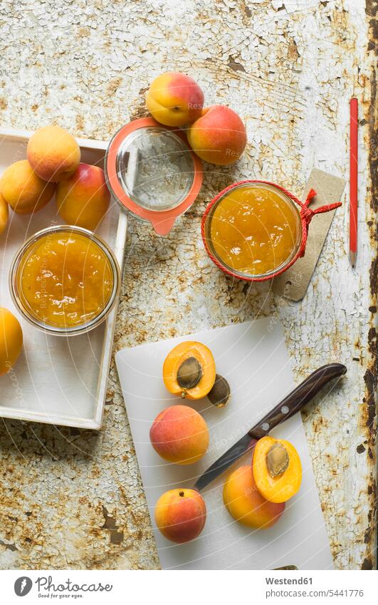 Two glasses of homemade apricot jam and apricots preserving jar Mason Jars mason jar preserving jars kilner jar preserves jar still life still-lifes still lifes