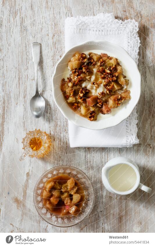 Bowl of porridge with rhubarb compote, honey and nuts ingredient ingredients prepared Honey Rhubarb Compote pieplant ready to eat ready-to-eat Bowls wooden Milk