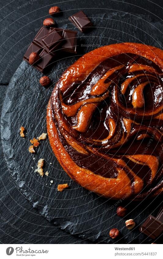 Chocolate cake, hazelnuts and bittersweet chocolate on slate black background black backgrounds pies cakes Hazelnut Hazel-Nut Hazelnuts Hazel-Nuts