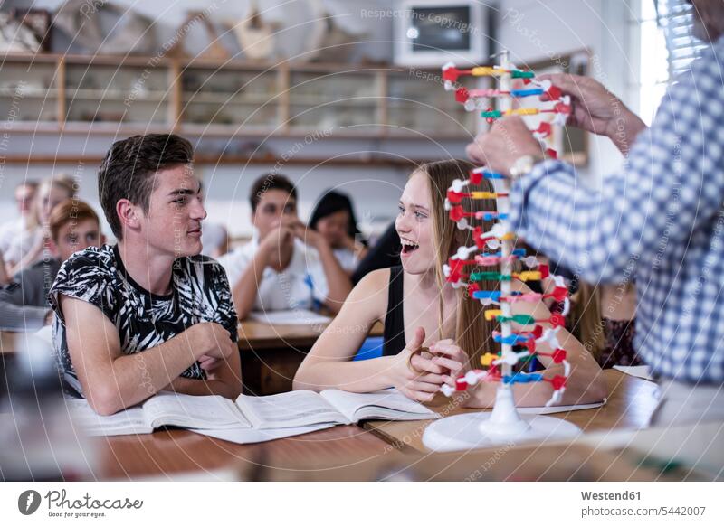 Teacher with DNA model and students in class school schools learning pupils education teacher instructor teachers pedagogue pedagogues schoolgirl female pupils