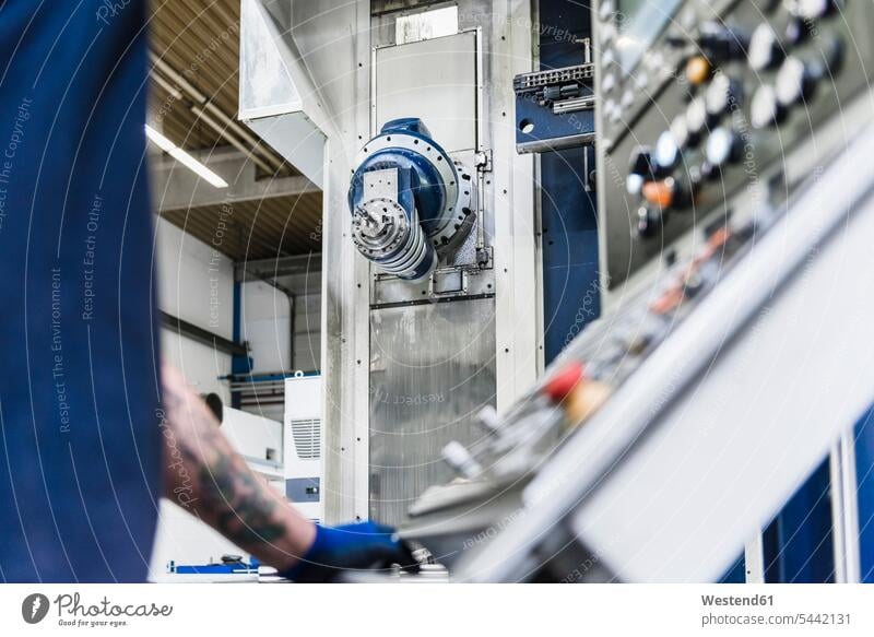 Close-up of man operating machine in industrial factory working At Work factories men males device devices Adults grown-ups grownups adult people persons