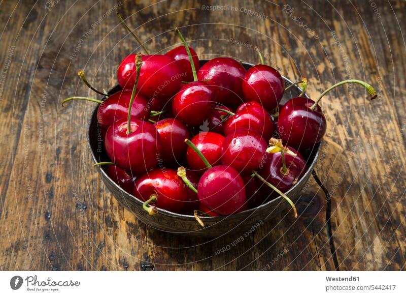 Bowl of cherries on wood food and drink Nutrition Alimentation Food and Drinks stalk Stipes Plant Stem stalks Stems Plant Stems wooden close-up close up