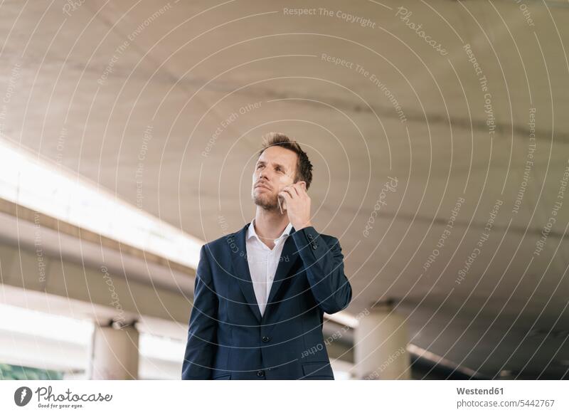 Businessman using futuristic smartphone on the phone call telephoning On The Telephone calling Business man Businessmen Business men telephone call Phone Call