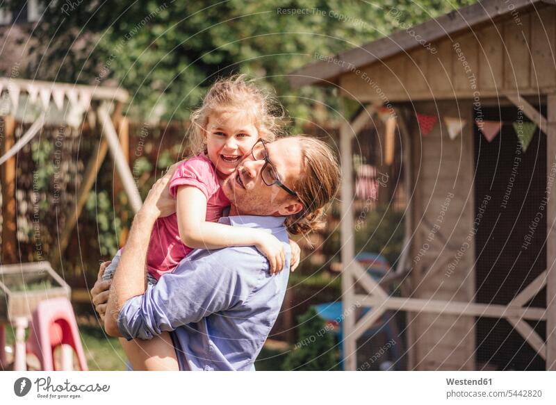 Father carrying daughter in garden daughters father pa fathers daddy dads papa gardens domestic garden child children family families people persons human being