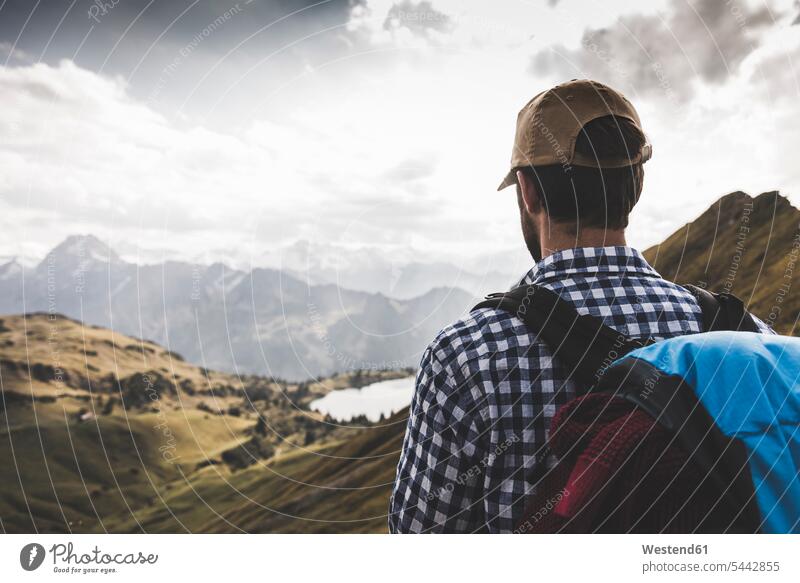 Italy, Sardinia, back view of man wearing hat looking at view - a Royalty  Free Stock Photo from Photocase