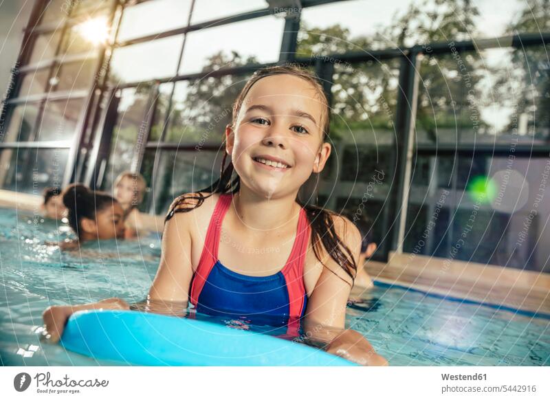 Teenager Girl bathing in-water in-a swimming pool with Friends on