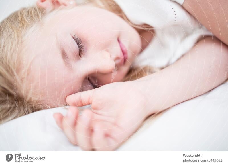 Girl sleeping on bed beds girl females girls asleep child children kid kids people persons human being humans human beings home at home indoors indoor shot