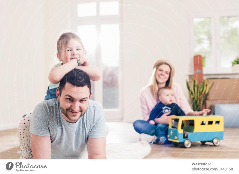Portrait of happy family in new home daughter daughters families flat flats apartment apartments child children people persons human being humans human beings