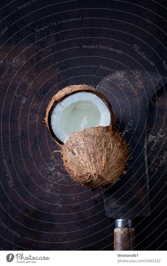 Opened coconut and old cleaver brown half halves halved tropical Tropical Climate hollow opened Brown Background dark background Cocos Shabby chic