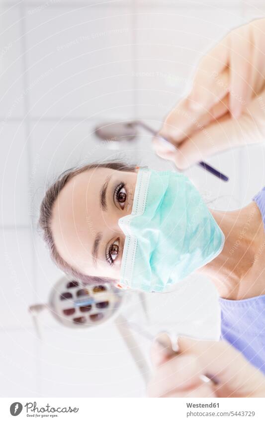 Personal perspective of female dentist with mask at work female dentists female dental surgeons portrait portraits woman females women doctor physicians doctors