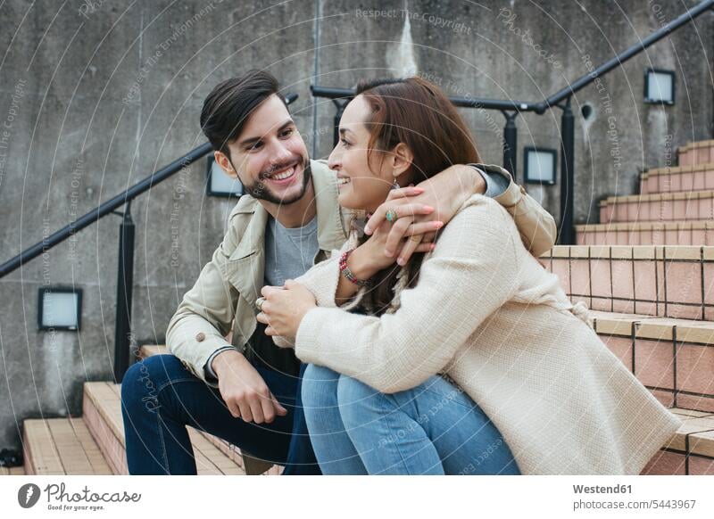 Couple in love sitting on stairs couple twosomes partnership couples people persons human being humans human beings happiness happy Seated smiling smile lovers