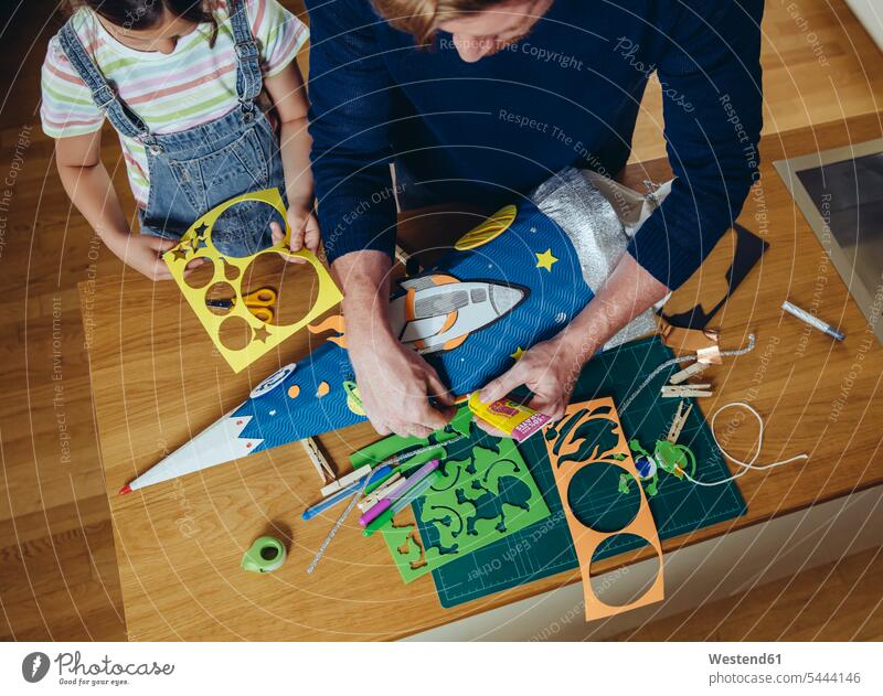 Father and daughter creating her space themed school cone at home school cones tinkering crafting doing handicrafts daughters father fathers daddy dads papa