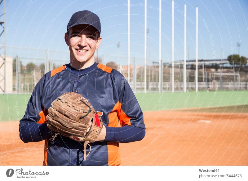 Portrait of smiling baseball player with a baseball glove baseball players smile portrait portraits sport sports sports field sports fields gloves training