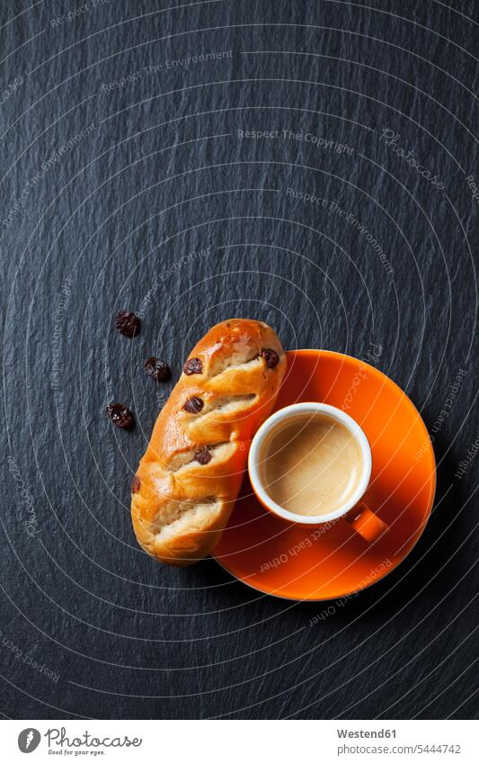 Chocolate bun with raisins and cup of espresso on slate food and drink Nutrition Alimentation Food and Drinks yeast dough currant bun scent flavor fragrance