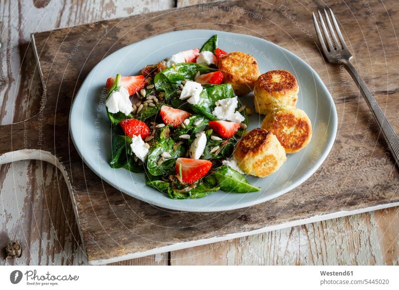 Plate of spinach salad with falafel, goat cheese, strawberries and sunflower seed garnished Spinach Spinacia Oleracea vegetarian Vegetarian Food Falafel patty