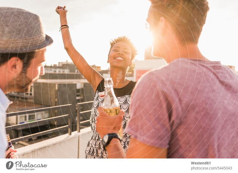 Friends having a rooftop party celebrating celebrate partying roof terrace deck Party Parties Fun having fun funny dancing dance friends laughing Laughter