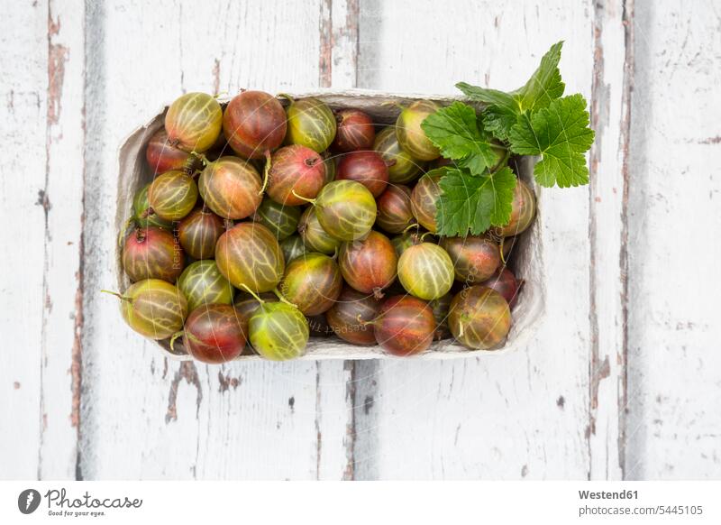 Cardboard box of gooseberries on wood boxes copy space Gooseberry Gooseberries raw healthy eating nutrition wooden many plenty large group of objects