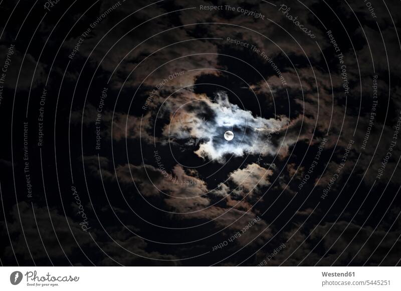 Full moon at cloudy night brightness glare luminescent impressive monumental nobody spooky haunting Weird Uncanny mysterious mystical Ominous sinister menacing