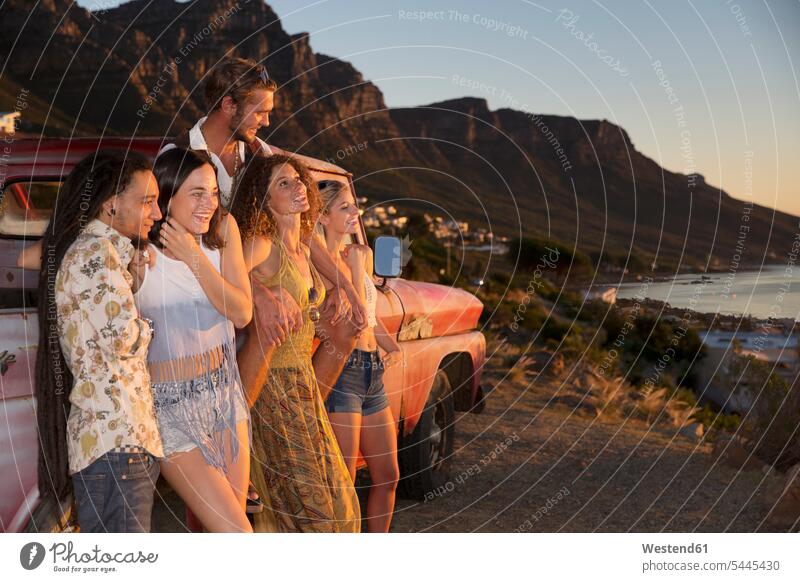 Young people outside pick up truck at the coast enjoying the sunset friends Fun having fun funny coastline shoreline friendship nonconformist unadapted