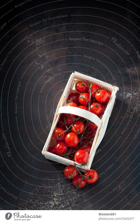 Splint basket of cherry tomatoes on dark grond overhead view from above top view Overhead Overhead Shot View From Above splint basket splint baskets