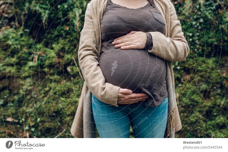 Close-up of pregnant woman in nature Pregnant Woman females women belly bellies abdomen human abdomen Adults grown-ups grownups adult people persons human being