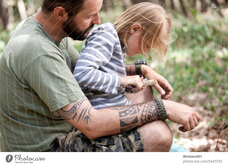 Father and daughter carving in the forest father pa fathers daddy dads papa Carving whittling woods forests daughters knife knives parents family families