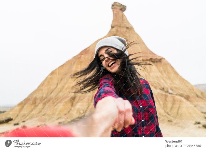 Spain, Navarra, Bardenas Reales, moving young woman holding hand of her boyfriend females women Adults grown-ups grownups adult people persons human being