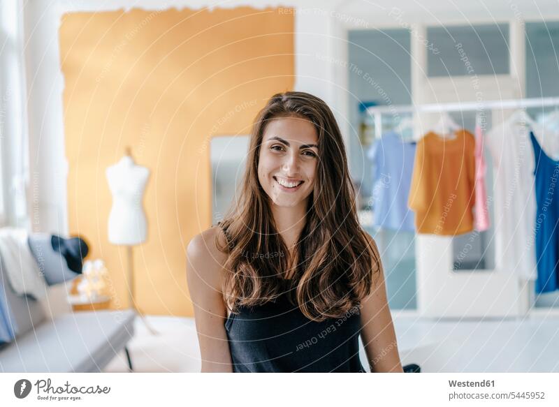 Portrait of happy young woman in fashion studio females women studios fashionable portrait portraits happiness brown hair brown haired brown-haired brunette